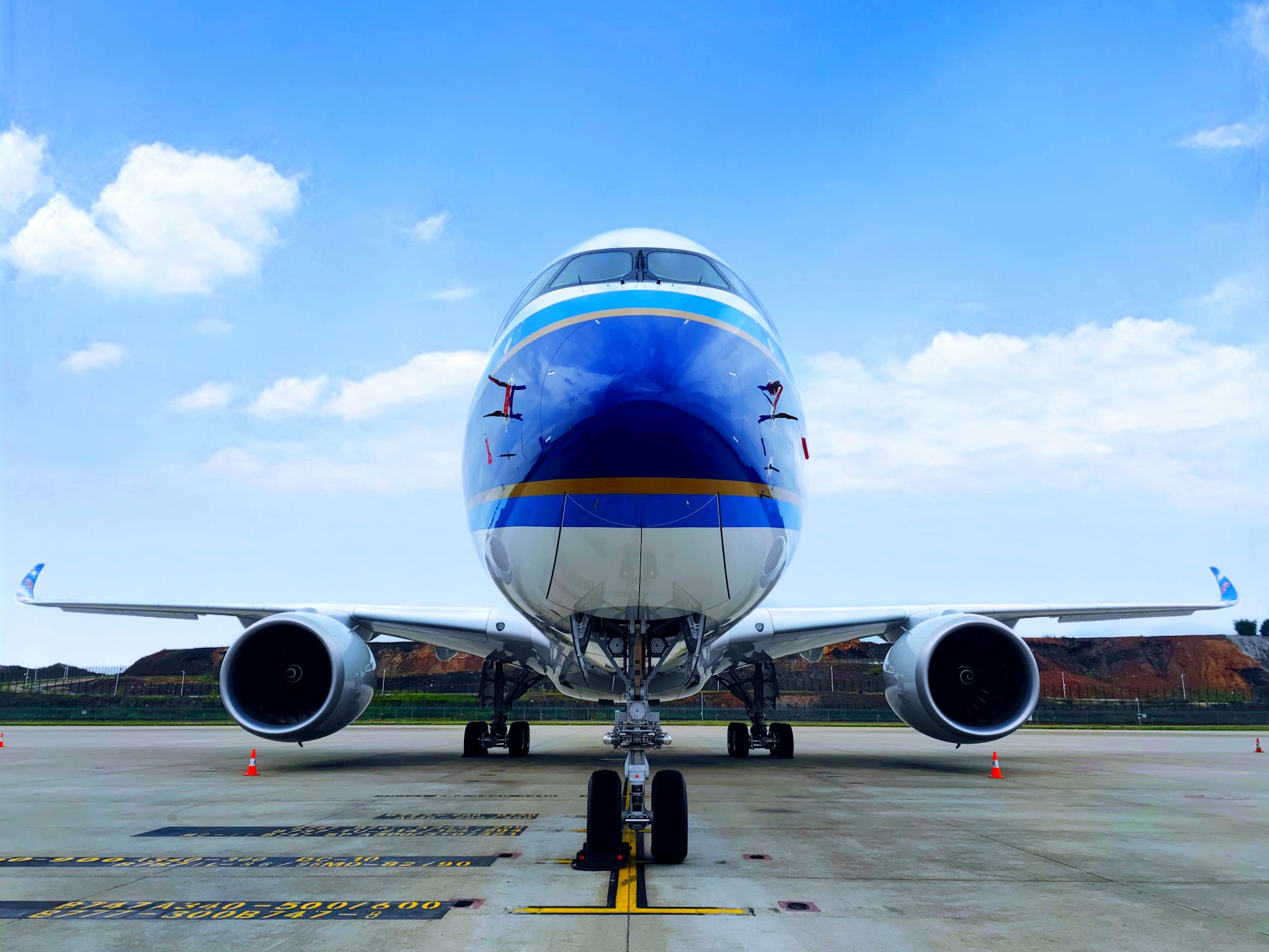 blue and white airplane under blue sky during daytime
